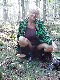 Older lady posing seductively in the woods