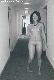 Flasher in motel hallway. Photographer husband is in background, in mirror.